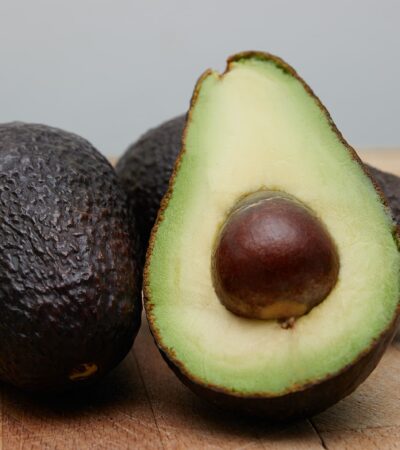 sliced avocado fruit on brown wooden table