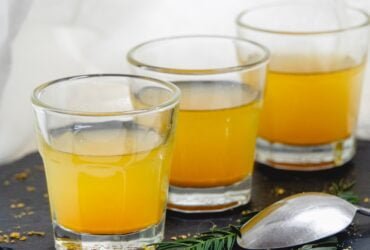 clear drinking glass with yellow liquid