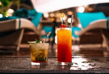 two drinks sitting on top of a table next to each other