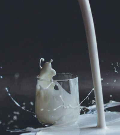 white candle in clear glass holder